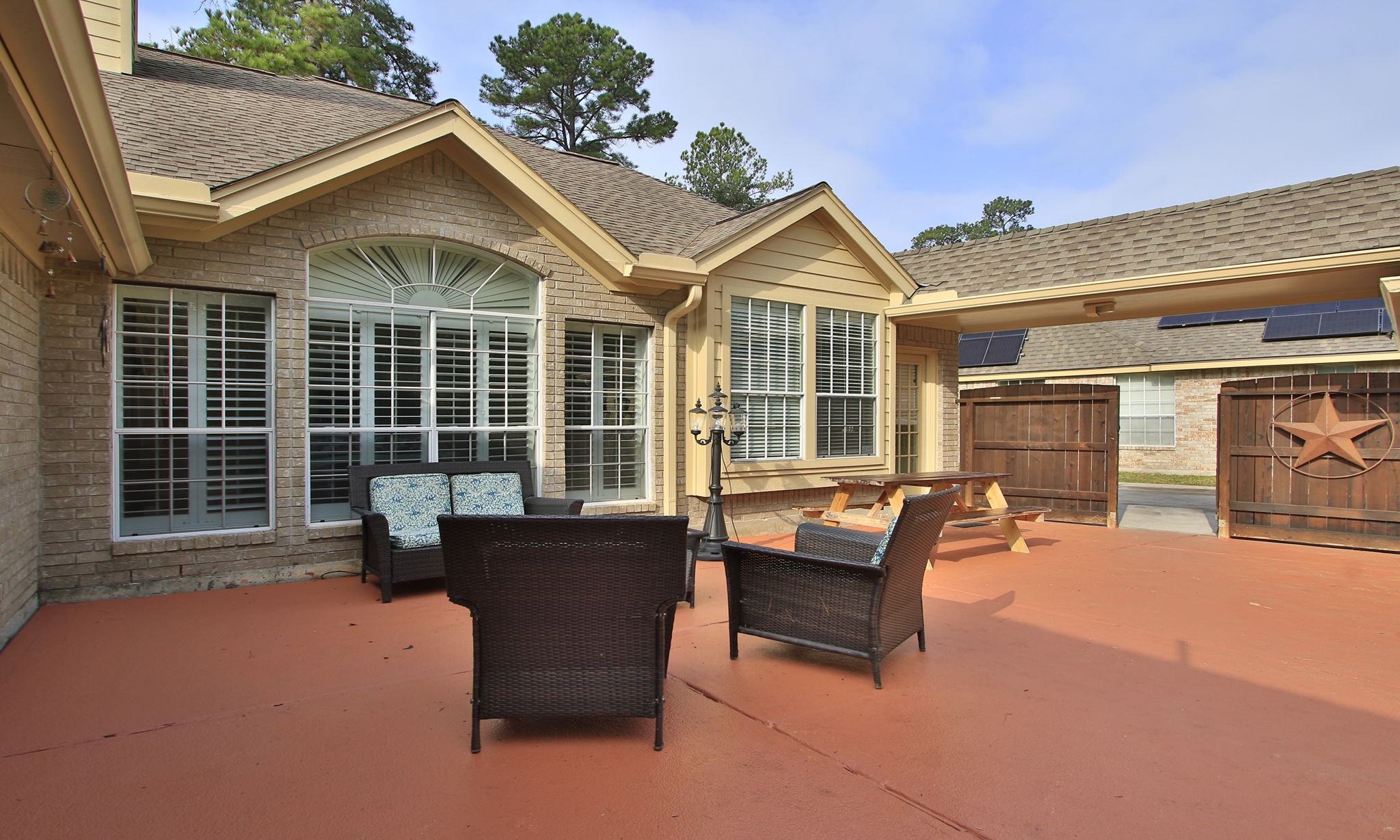 20206 Treetop Lane Spring, TX 77388 - Photo 36 of 42 a view of a house with a barbeque and wooden bench