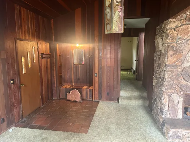 a kitchen with granite countertop a stove a sink dishwasher and cabinets with wooden floor