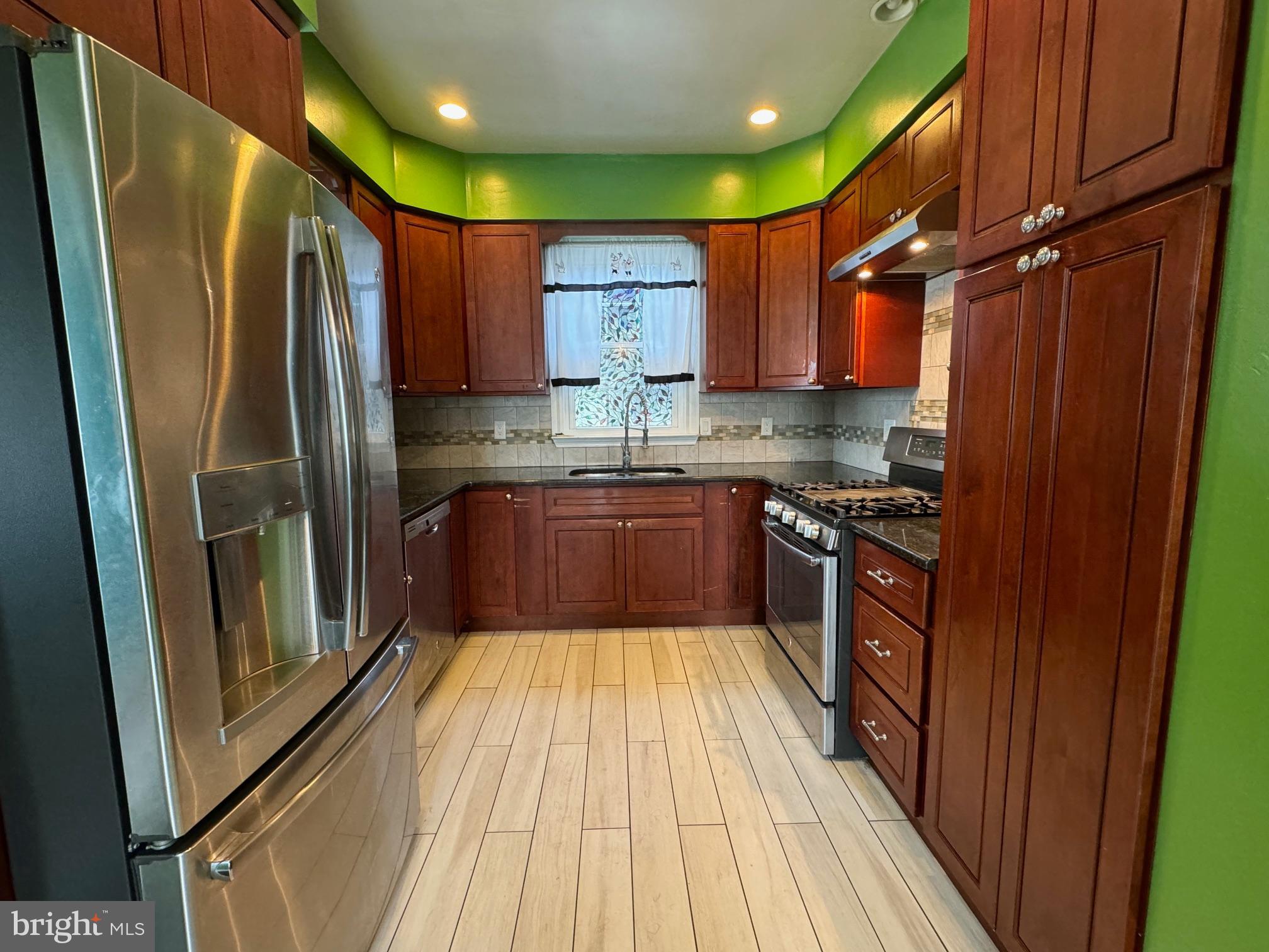 334 Delaware Avenue Riverside, NJ 08075 - Photo 4 of 28 a kitchen with stainless steel appliances granite countertop a refrigerator a sink dishwasher a stove top oven a refrigerator and cabinets