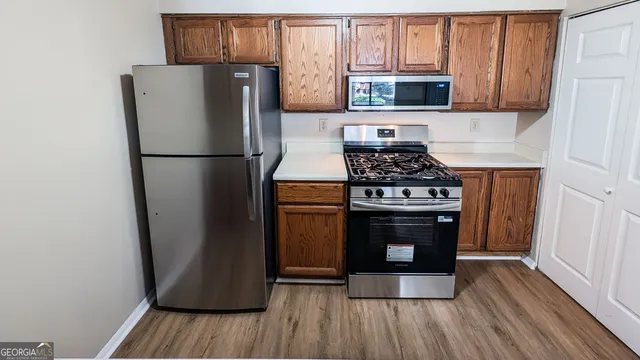 a kitchen with a stove and a refrigerator