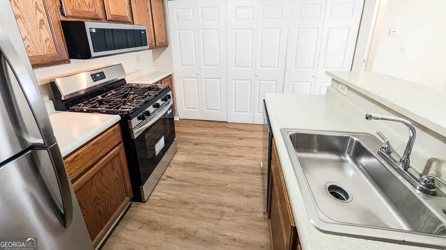 a kitchen with a sink and a stove top oven