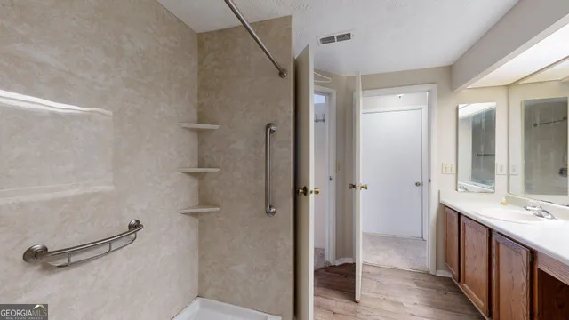 a bathroom with a double vanity sink toilet and shower