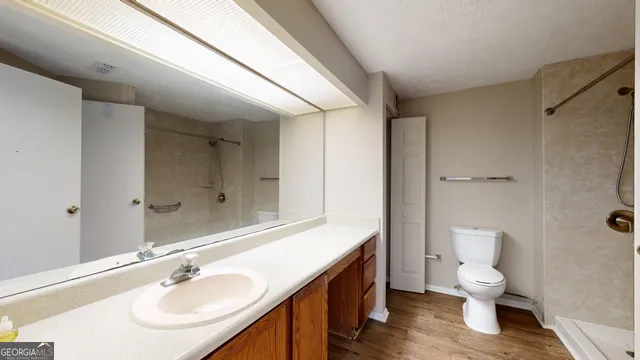 a bathroom with a toilet a sink and mirror