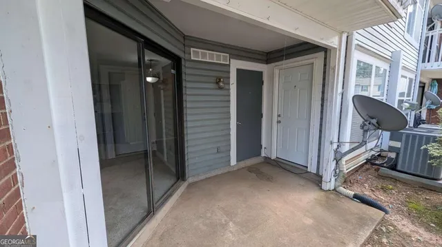 a view of a hallway with closet and mirror