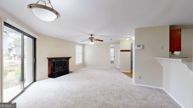 a view of a livingroom with a fireplace and cabinet