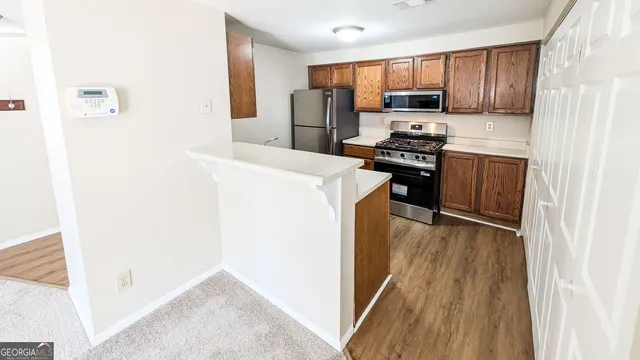 a kitchen with a refrigerator a stove top oven a sink and dishwasher