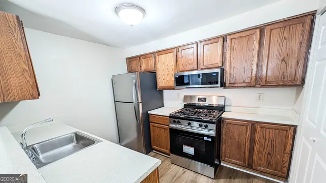 a kitchen with stainless steel appliances a stove a microwave and a refrigerator