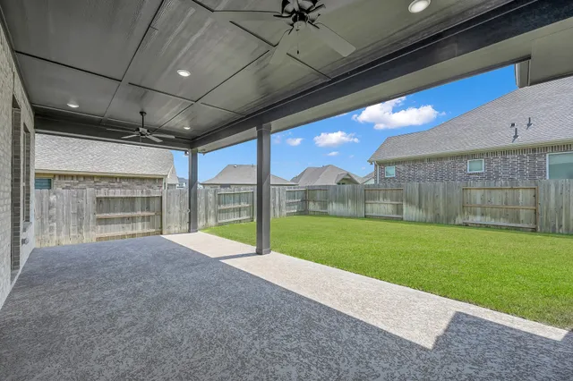 a view of a house with backyard and porch