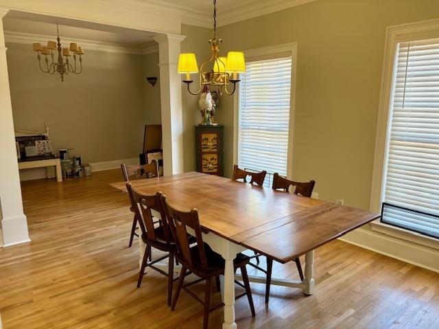 4310 Enoch Road Aynor, SC 29511 - Photo 8 of 39 Dining area featuring a chandelier, light wood-style floors, crown molding, and ornate columns