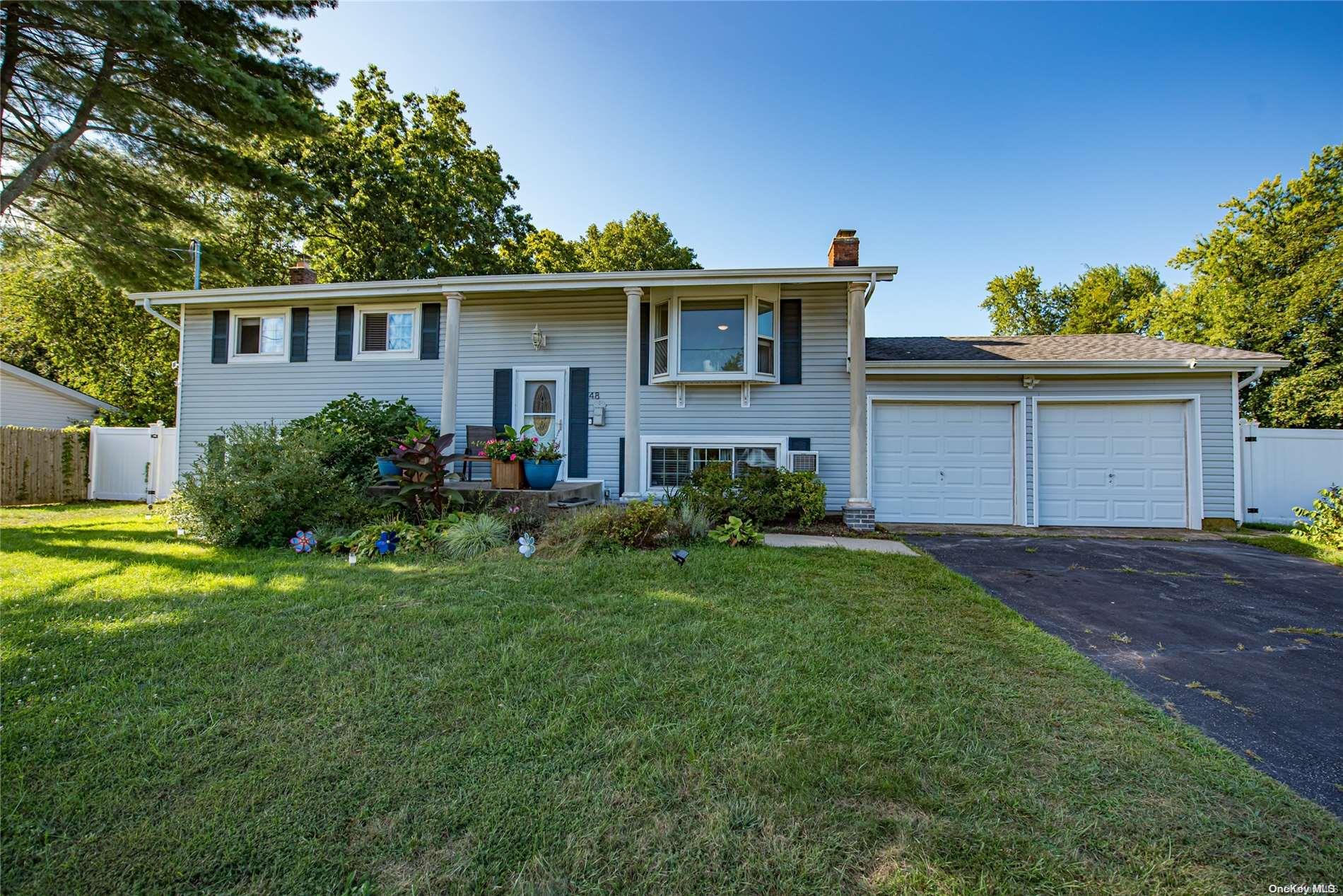 48 Clearview Drive Wheatley Heights, NY 11798 - Photo 1 of 1 a front view of a house with a yard and garage