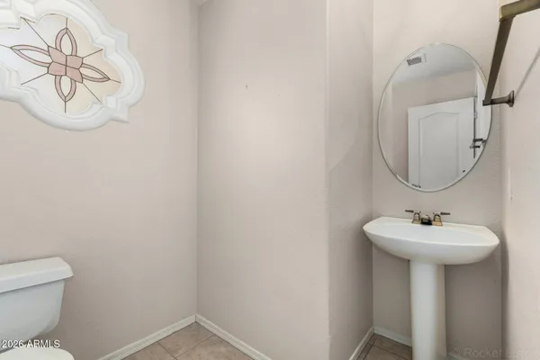 a bathroom with a sink toilet and a mirror