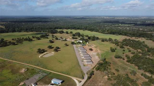 an aerial view of a residential houses with outdoor space
