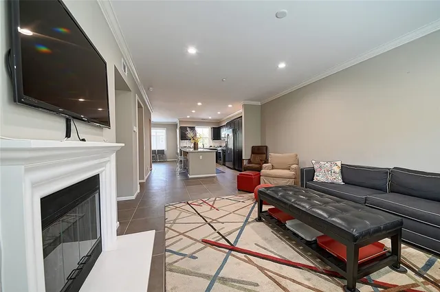 a living room with furniture and kitchen view