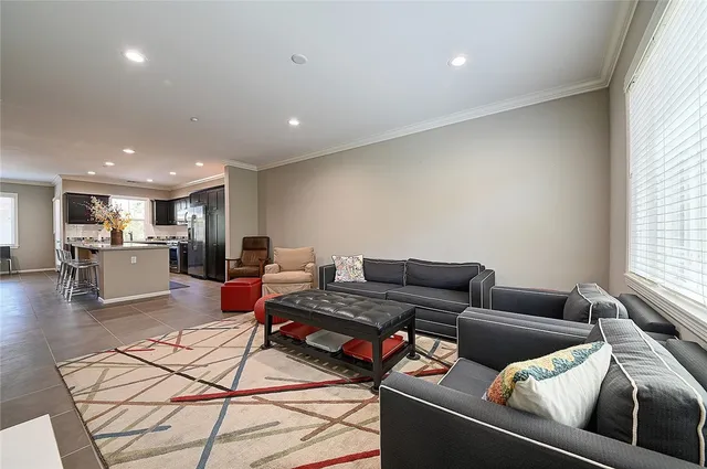 a large kitchen with stainless steel appliances a large counter top a stove and a refrigerator