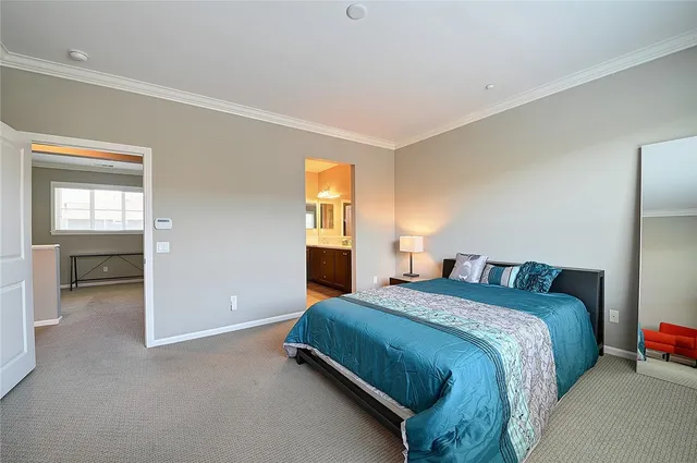 a bathroom with a granite countertop double vanity sink a mirror and a shower