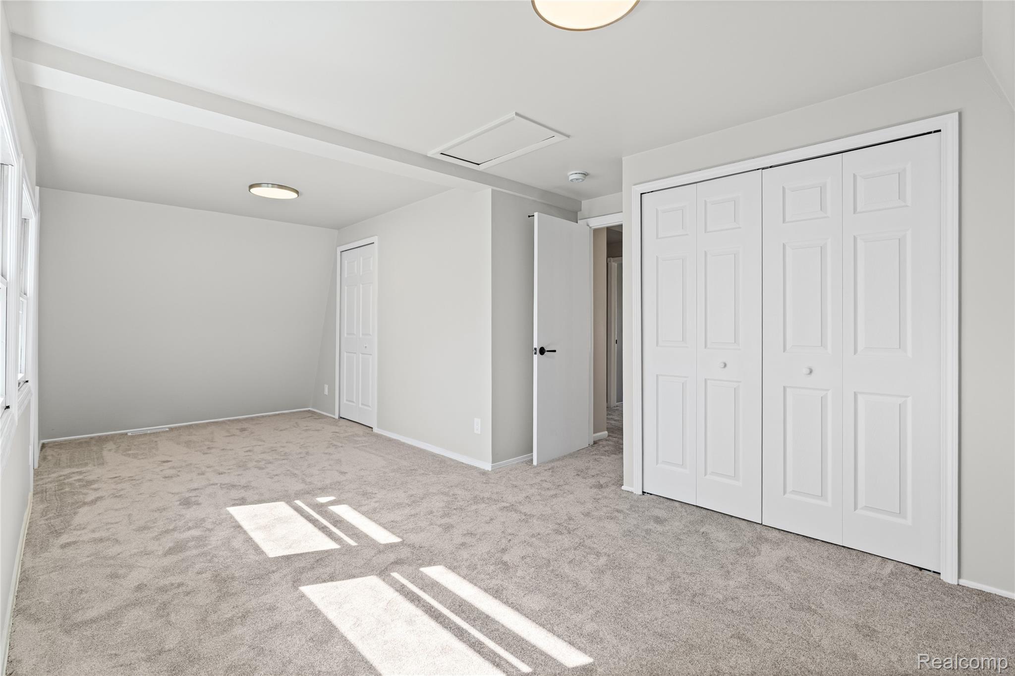 6273 Cold Spring Trail Grand Blanc, MI 48439 - Photo 30 of 48 Bedroom 1 featuring light carpet and two closets
