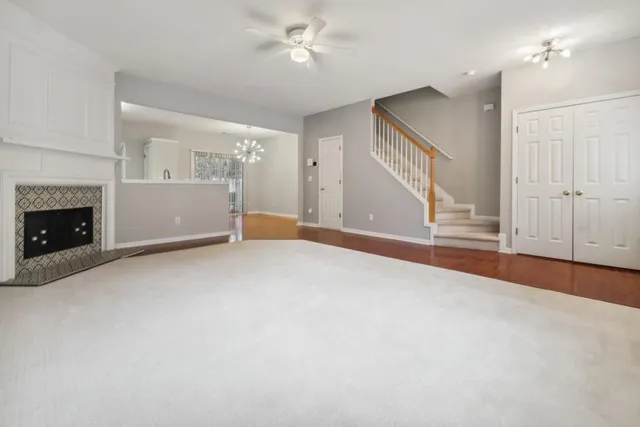 a view of empty room with fireplace and fan