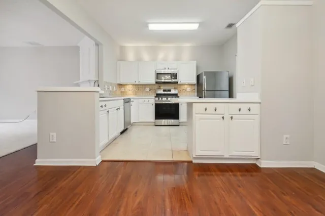 a kitchen with a stove top oven sink and cabinets