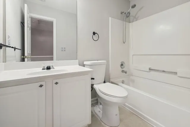 a bathroom with a sink toilet vanity and shower