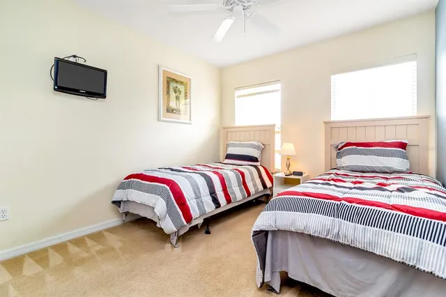 a bedroom with two beds and a night stand