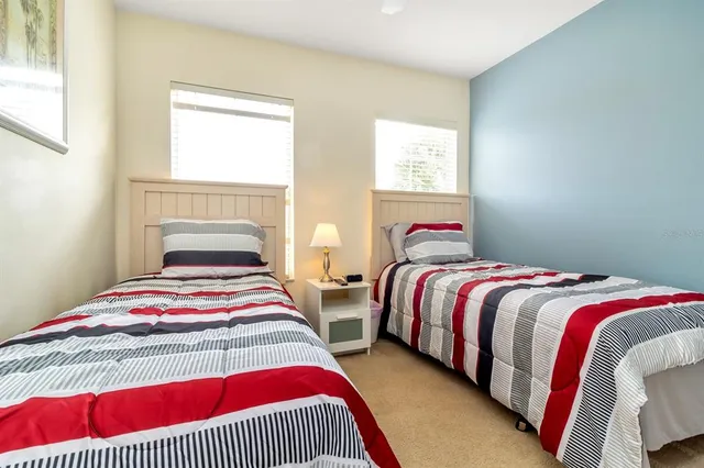 a bedroom with two beds and a window