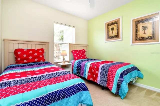 a bedroom with two beds and a window