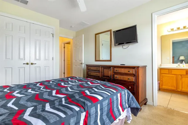 a bedroom with a bed and a flat screen tv