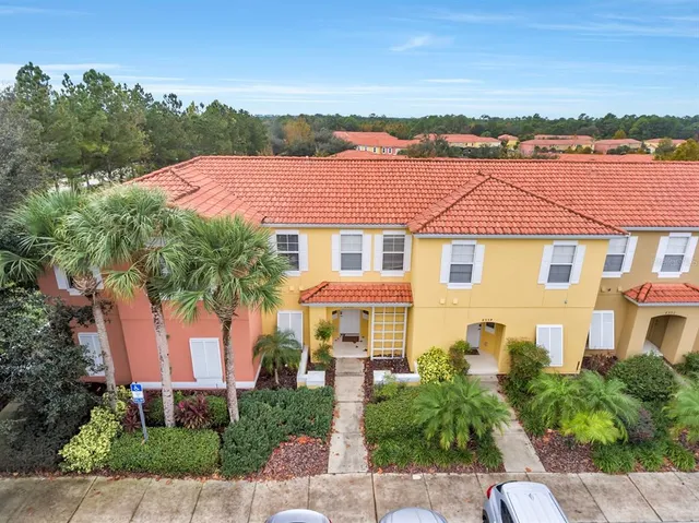 a front view of a house with a yard and lake view