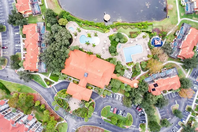 an aerial view of swimming pool outdoor seating and yard