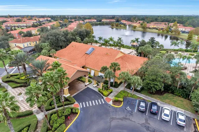 an aerial view of a house with a garden and lake view