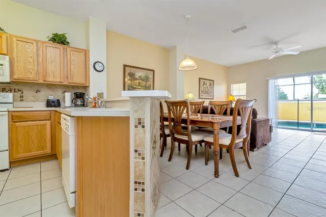 a view of a dining room with furniture and a kitchen