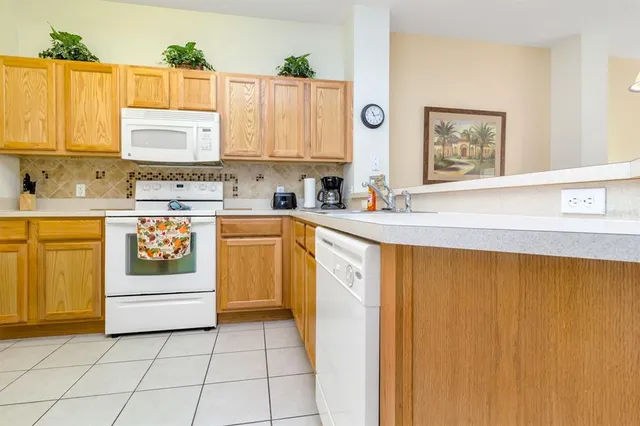 a kitchen with a white cabinets and white appliances