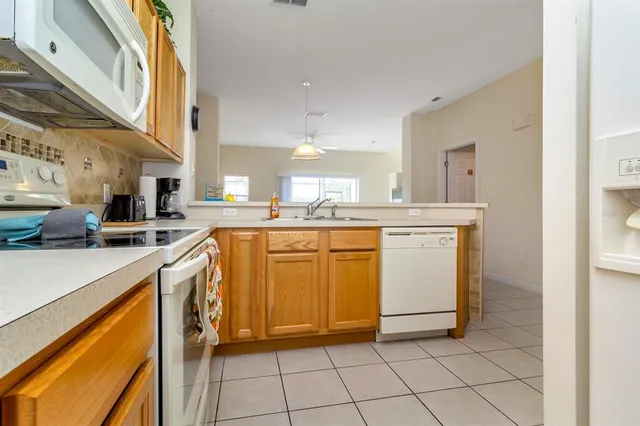 a kitchen with cabinets and white appliances