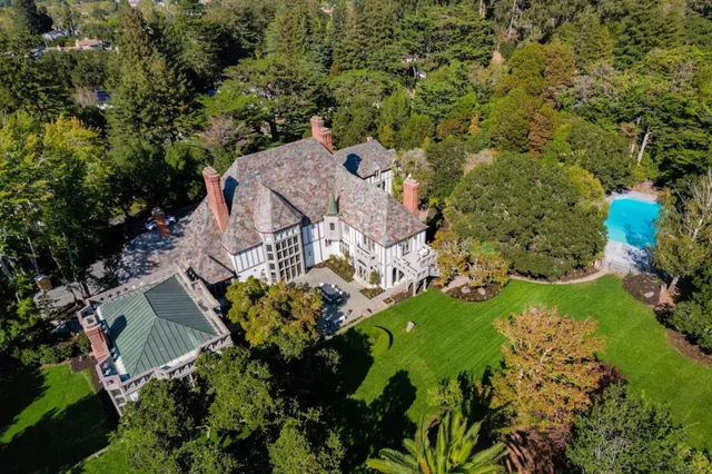 an aerial view of a house with a yard