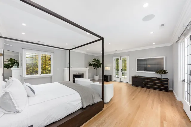 a spacious bedroom with a large bed and a couch