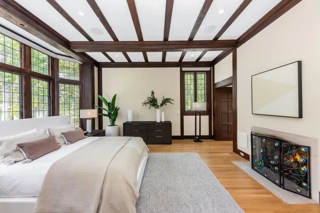 a living room with furniture a fireplace and a large window