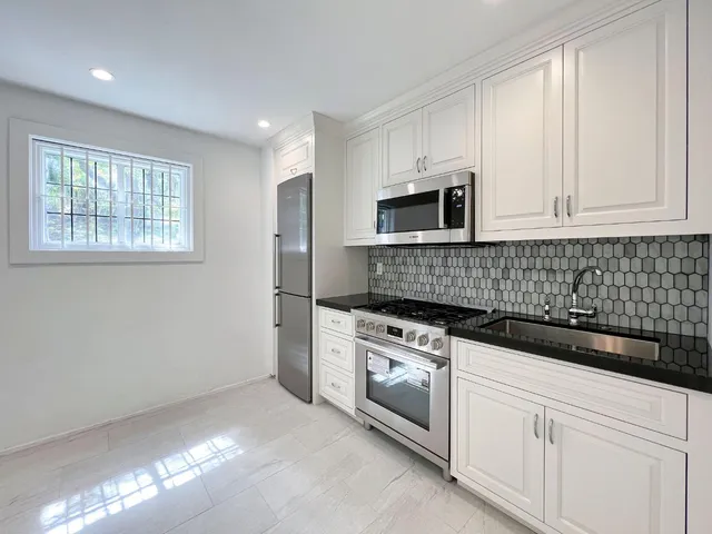 a view of a patio with a table and chairs under an umbrella