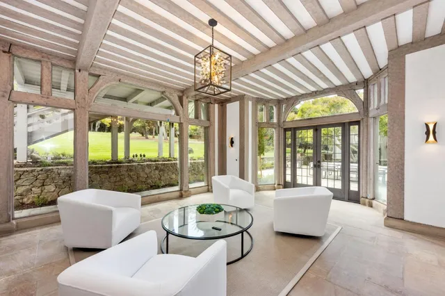 a view of a patio with table and chairs and potted plants