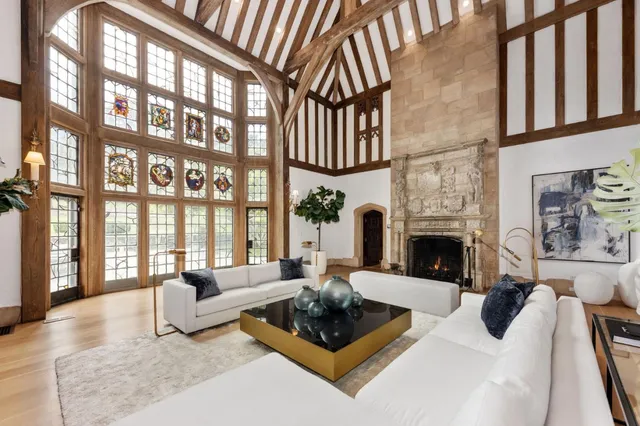 a living room with furniture and large windows