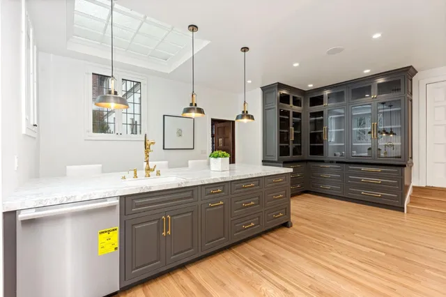 a large kitchen with stainless steel appliances granite countertop a stove a sink and a granite counter tops