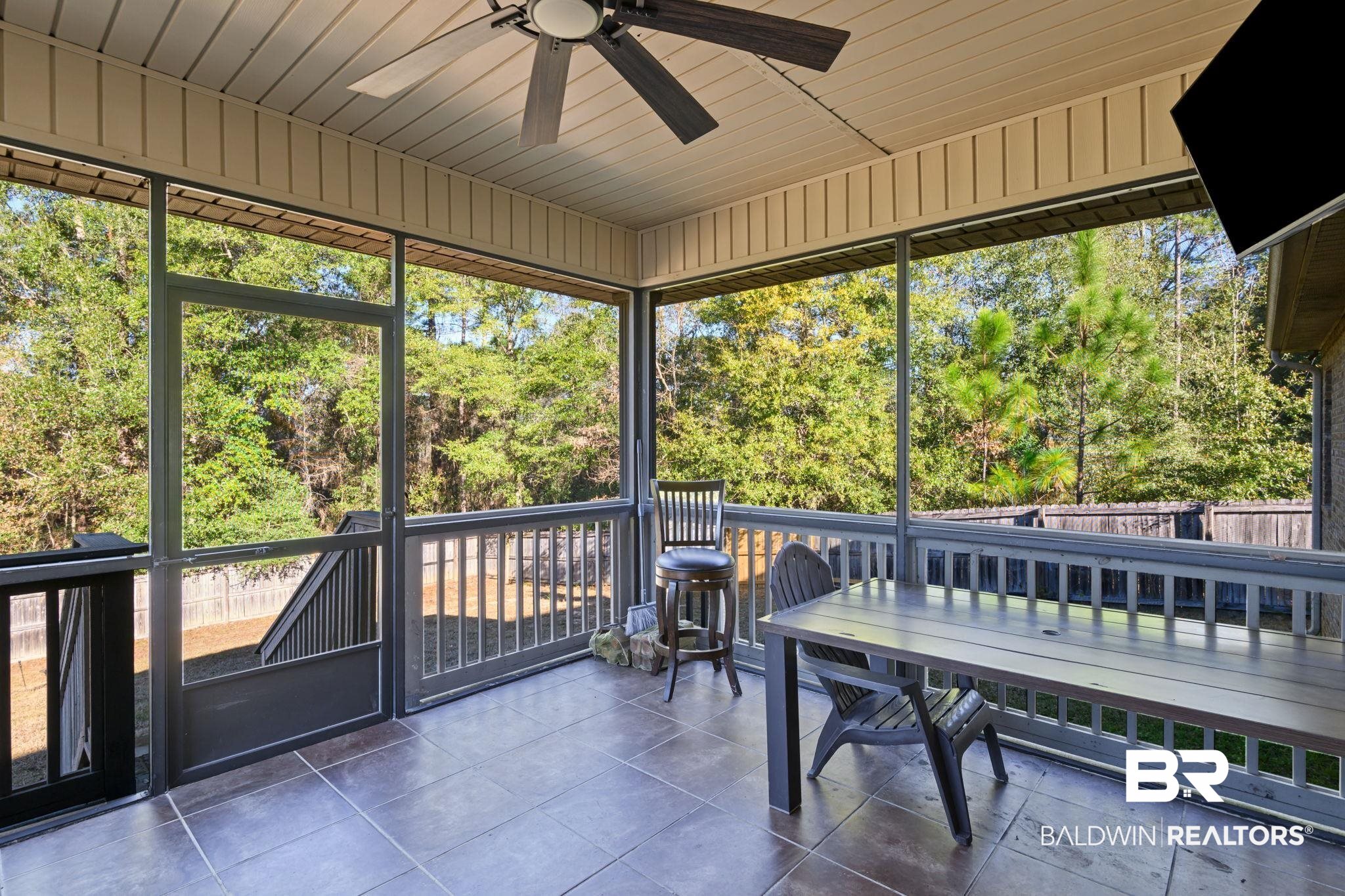 7506 Carlson Court Mobile, AL 36619 - Photo 9 of 33 Sunroom featuring a ceiling fan and view of scattered trees