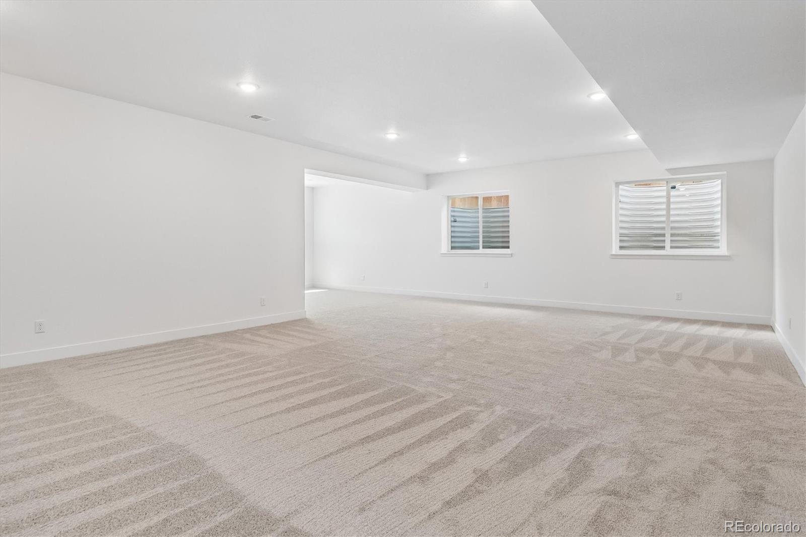 2536 West Bitterroot Place Highlands Ranch, CO 80129 - Photo 15 of 33 an empty room with wooden floor and windows