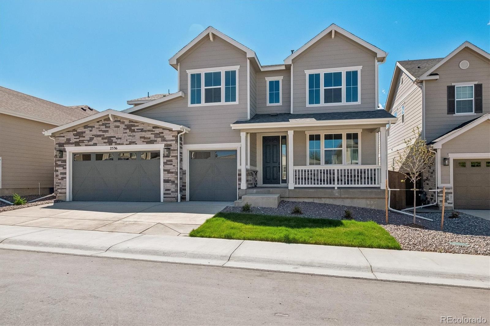 2536 West Bitterroot Place Highlands Ranch, CO 80129 - Photo 2 of 33 a front view of a house with a yard and garage