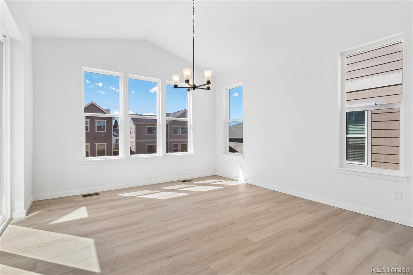 2536 West Bitterroot Place Highlands Ranch, CO 80129 - Photo 8 of 33 a view of an empty room with a window and wooden floor