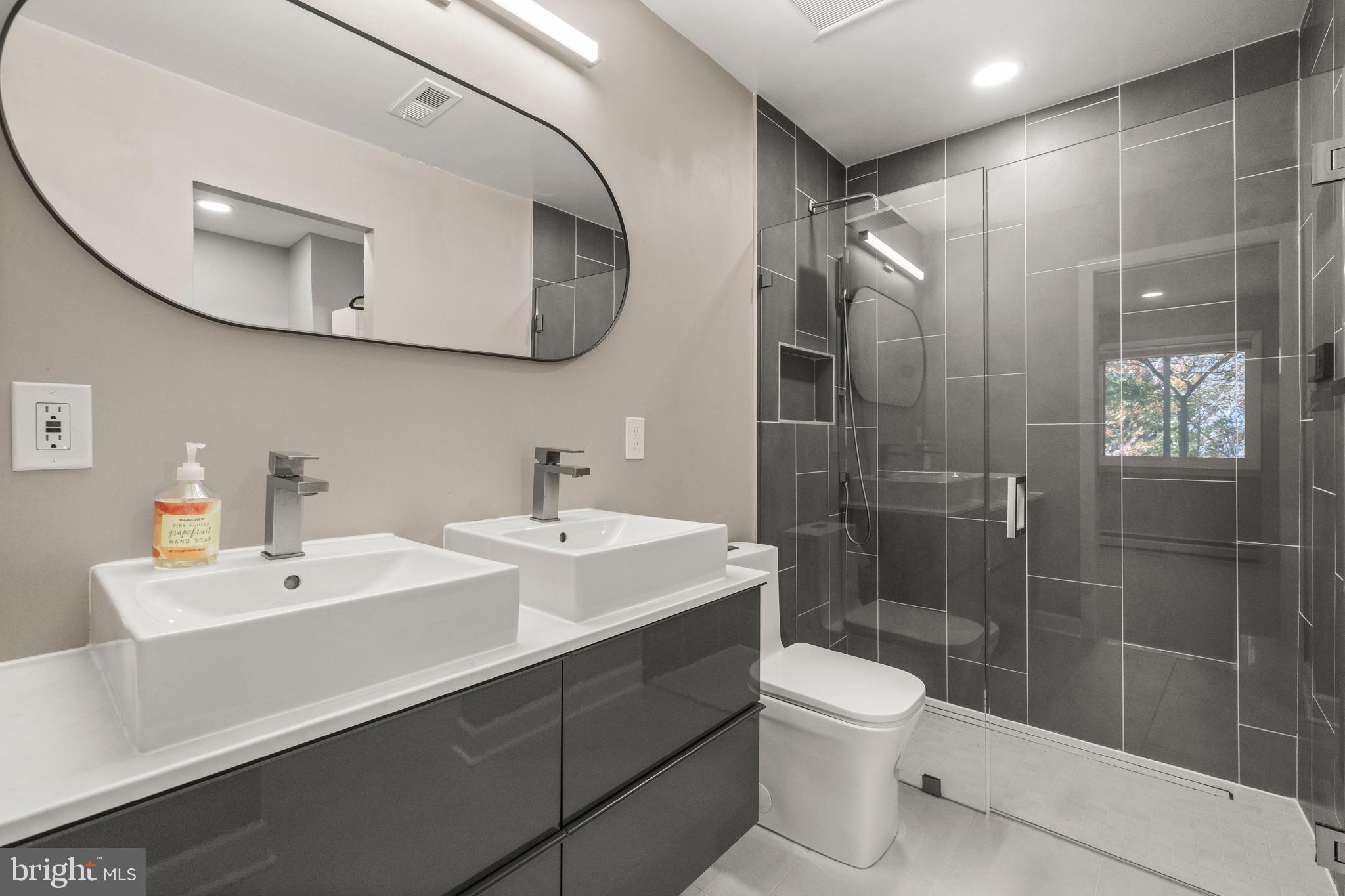 2152 Glencourse Lane Reston, VA 20191 - Photo 22 of 52 a bathroom with a toilet a sink a mirror and shower