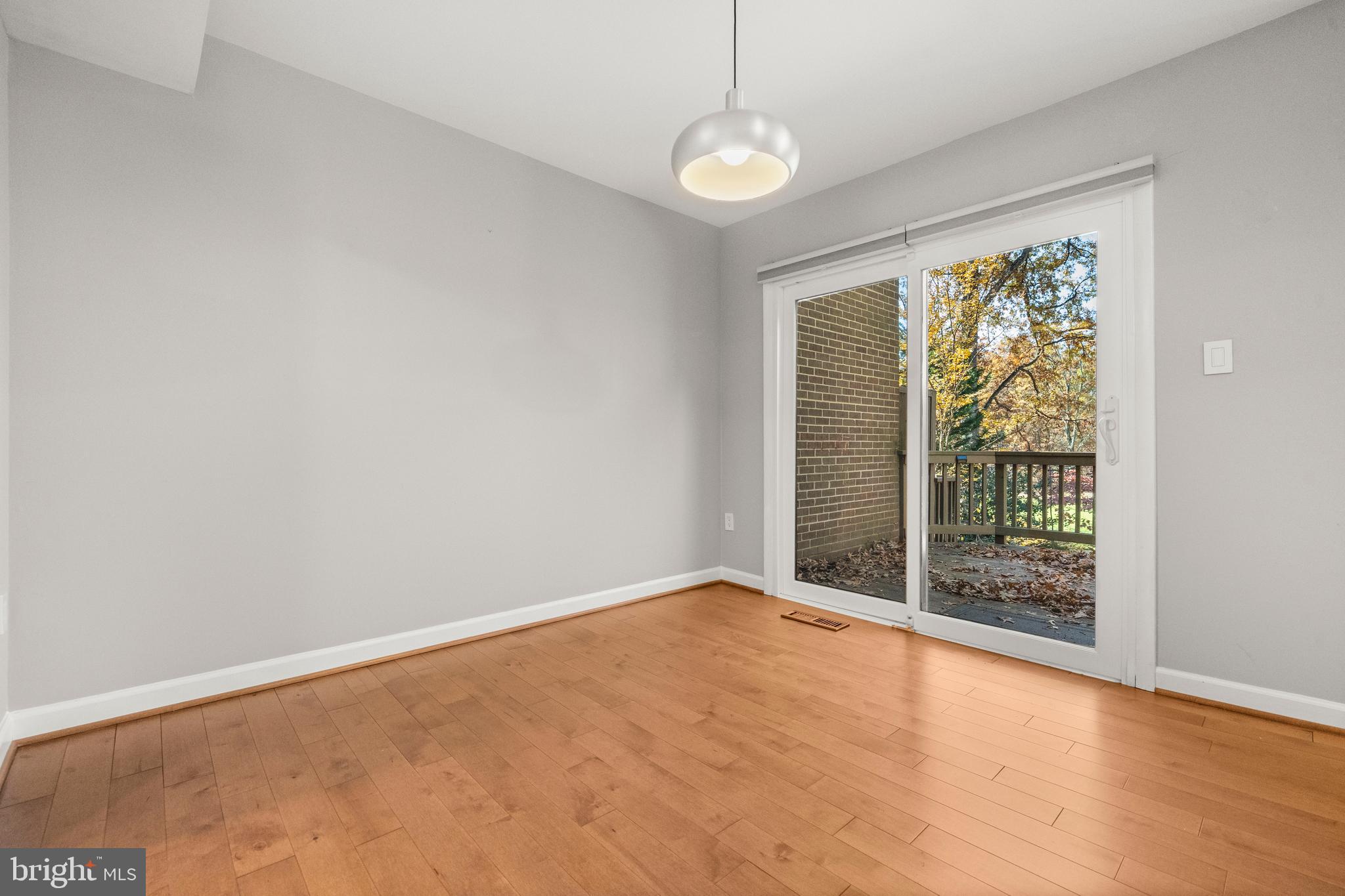 2152 Glencourse Lane Reston, VA 20191 - Photo 7 of 52 a view of an empty room with wooden floor and a window