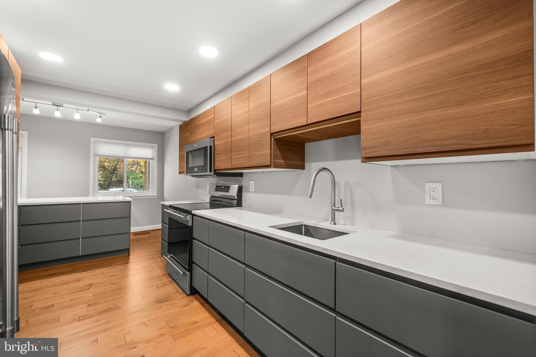 2152 Glencourse Lane Reston, VA 20191 - Photo 9 of 52 a large kitchen with kitchen island a sink stainless steel appliances and cabinets