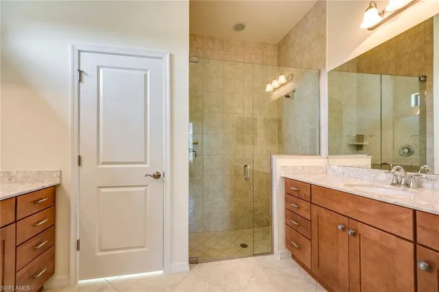 a bathroom with a granite countertop sink mirror vanity and toilet