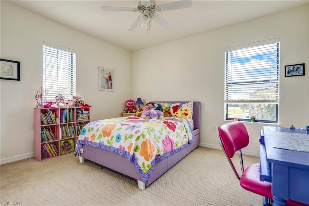 1308 Kendari Terrace Naples, FL 34113 - Photo 16 of 21 Carpeted bedroom featuring ceiling fan and baseboards