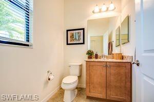 1308 Kendari Terrace Naples, FL 34113 - Photo 17 of 21 Half bathroom with vanity and toilet